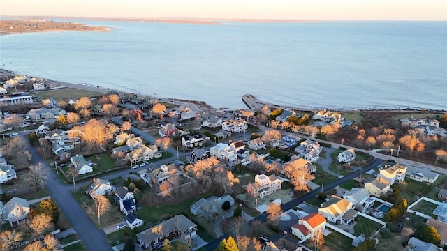 aerial view at dusk featuring a water view