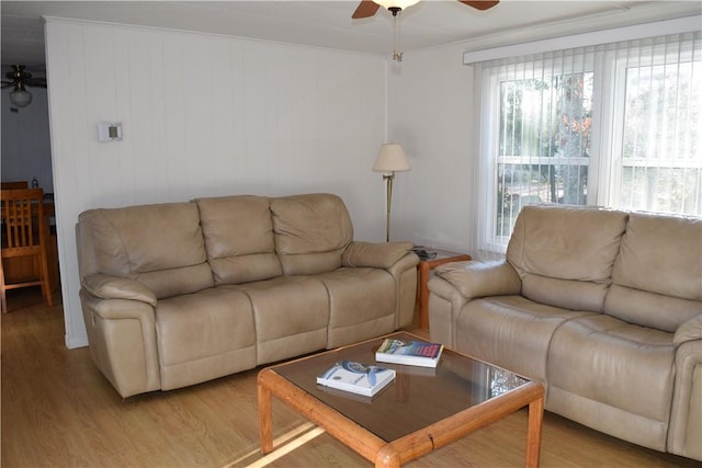 living room with hardwood / wood-style flooring and crown molding