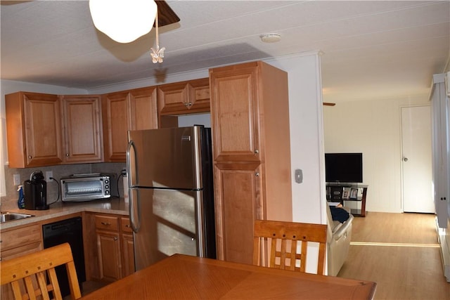 kitchen featuring dishwasher, light wood-type flooring, tasteful backsplash, and stainless steel refrigerator