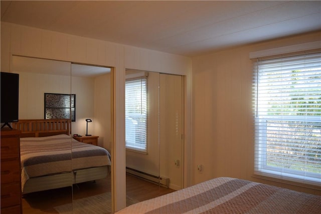 bedroom with wood-type flooring and a baseboard radiator