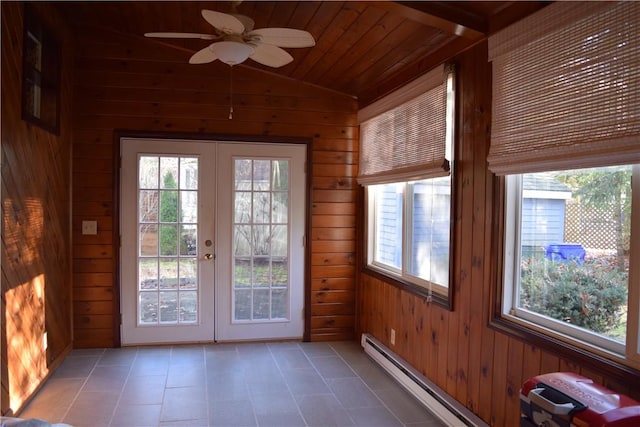 entryway featuring wood walls, lofted ceiling, and french doors