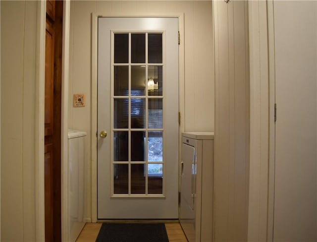 entryway with washer and dryer and light wood-type flooring