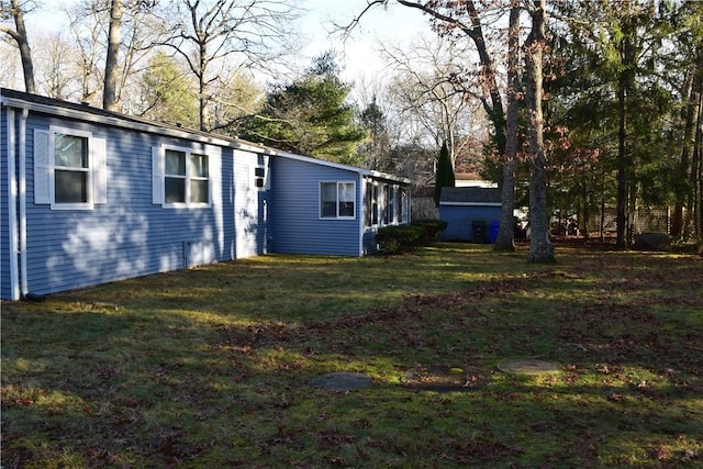 rear view of property with a sunroom and a yard