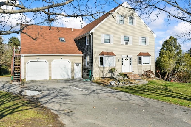 view of front of home featuring a garage and a front yard