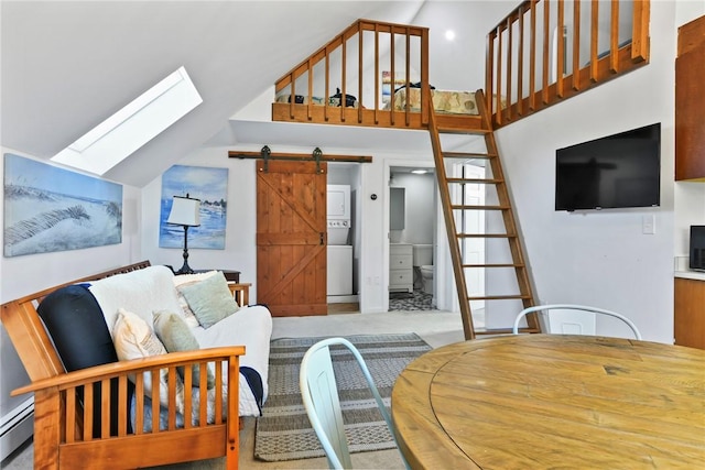 carpeted living room with a barn door, high vaulted ceiling, a skylight, and a baseboard heating unit