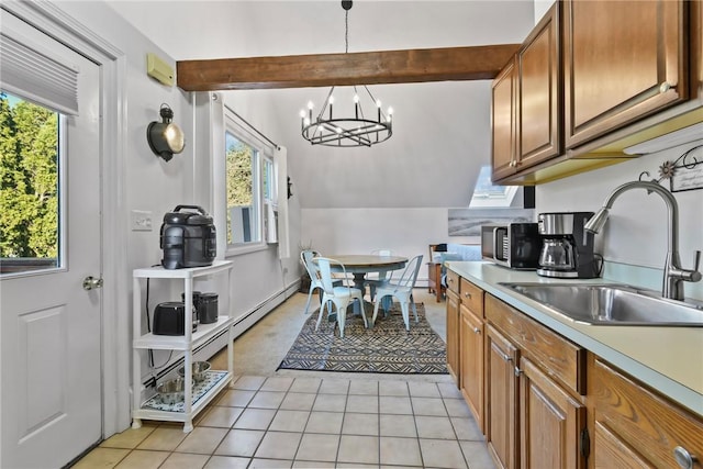 kitchen with pendant lighting, an inviting chandelier, sink, vaulted ceiling with beams, and light tile patterned flooring