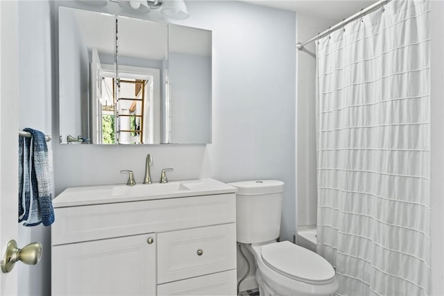 full bathroom featuring vanity, shower / bath combo, and toilet