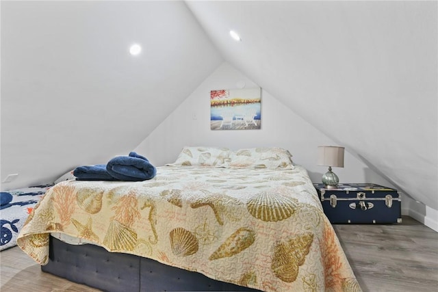 bedroom featuring hardwood / wood-style flooring and vaulted ceiling