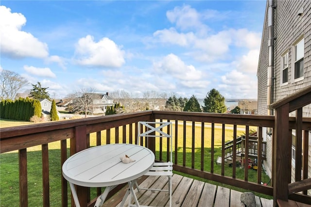 wooden deck with a lawn