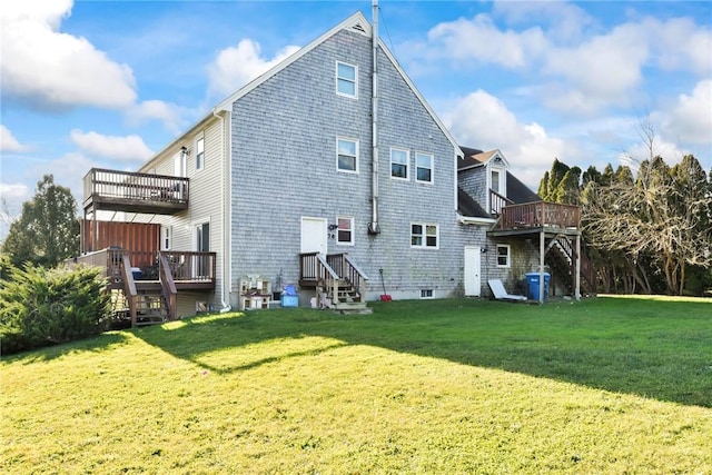 back of property featuring a lawn and a wooden deck