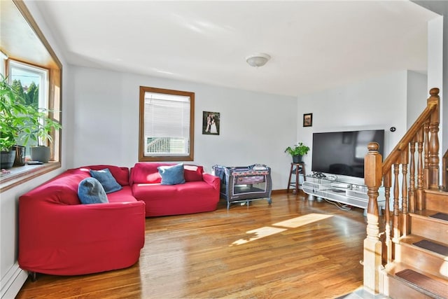 living room featuring wood-type flooring and baseboard heating