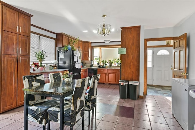 dining area featuring crown molding, light tile patterned floors, and a chandelier