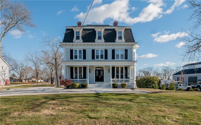 view of front facade with covered porch and a front yard