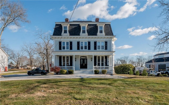 view of front of house featuring covered porch and a front lawn