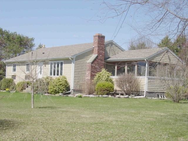 back of house with a lawn