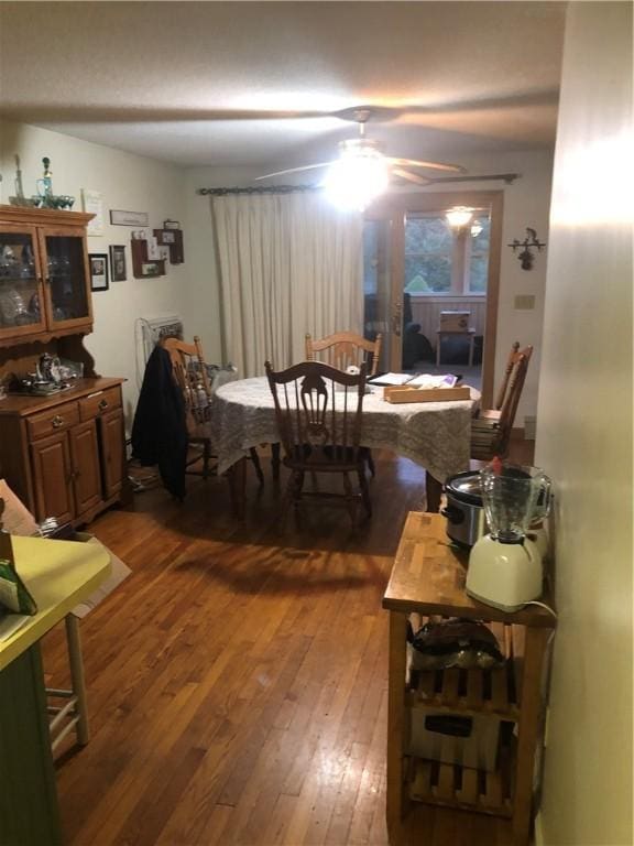 dining space with dark hardwood / wood-style flooring