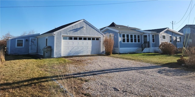 ranch-style home featuring a garage and a front lawn