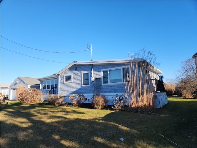 rear view of property featuring a lawn