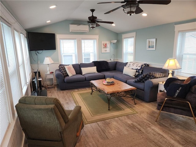 living room featuring a wall mounted air conditioner, ceiling fan, vaulted ceiling, and light hardwood / wood-style flooring