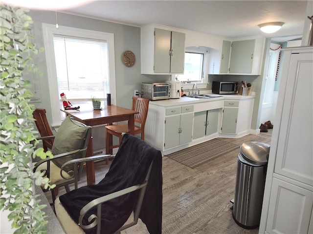 kitchen with light hardwood / wood-style floors and sink