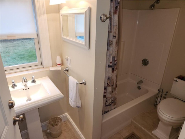 bathroom with toilet, tile patterned floors, and shower / tub combo with curtain