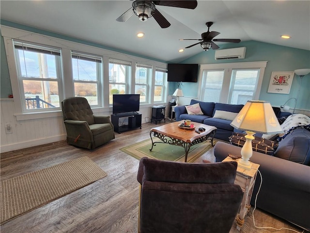 living room with ceiling fan, vaulted ceiling, light wood-type flooring, and a wall mounted AC