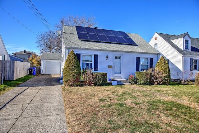 view of front facade featuring a front yard, solar panels, and a garage