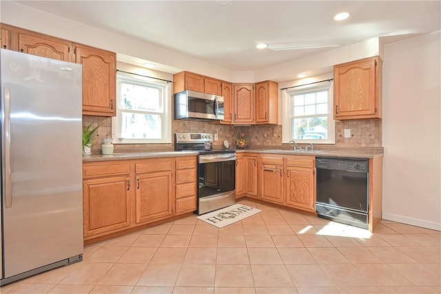 kitchen featuring light tile patterned flooring, stainless steel appliances, tasteful backsplash, and sink