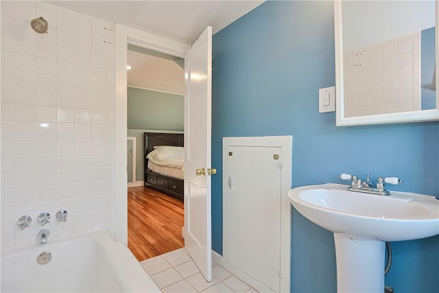 bathroom featuring hardwood / wood-style floors and tiled shower / bath combo