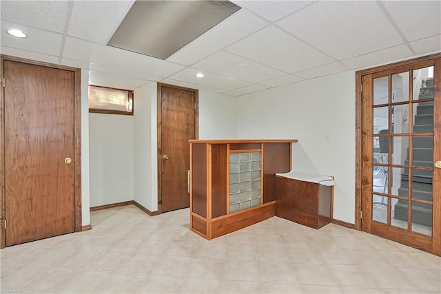 empty room with a paneled ceiling and french doors