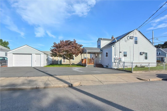 view of front of property featuring a garage and an outdoor structure