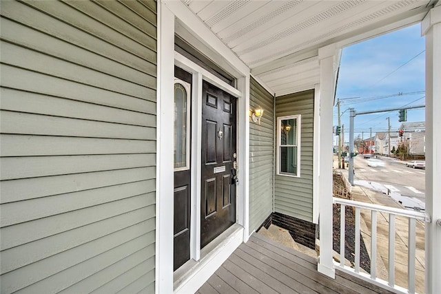 view of exterior entry with covered porch