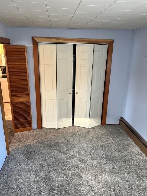 unfurnished bedroom featuring carpet and a closet