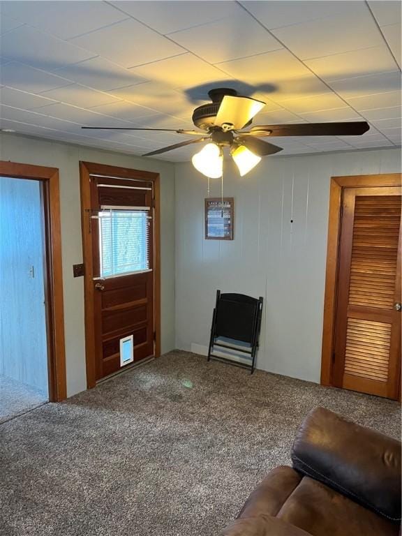 unfurnished living room featuring carpet flooring and ceiling fan