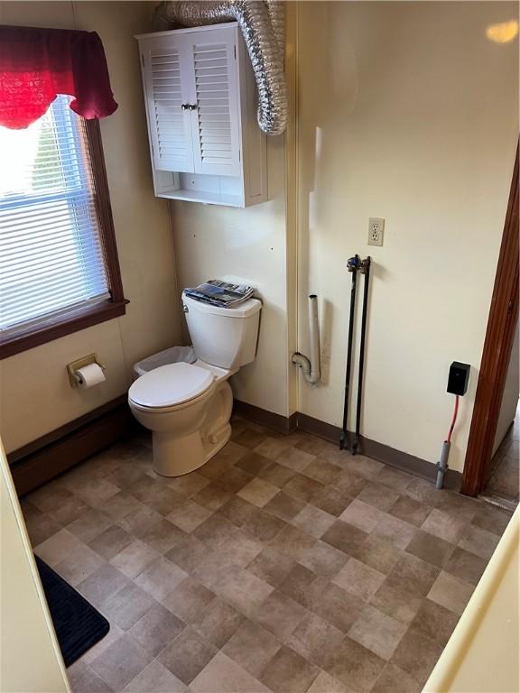 bathroom with toilet and baseboard heating