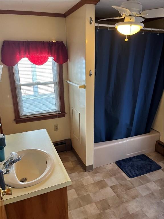 bathroom with vanity, a baseboard radiator, shower / bath combo, and ornamental molding