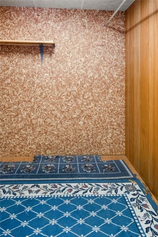 mudroom featuring wood walls