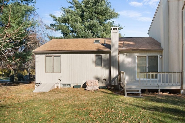 rear view of house featuring a yard