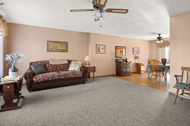 living room featuring ceiling fan and hardwood / wood-style floors