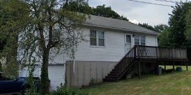 view of property exterior featuring a deck and a yard