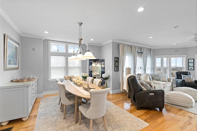 dining room with light hardwood / wood-style floors, ceiling fan, and crown molding