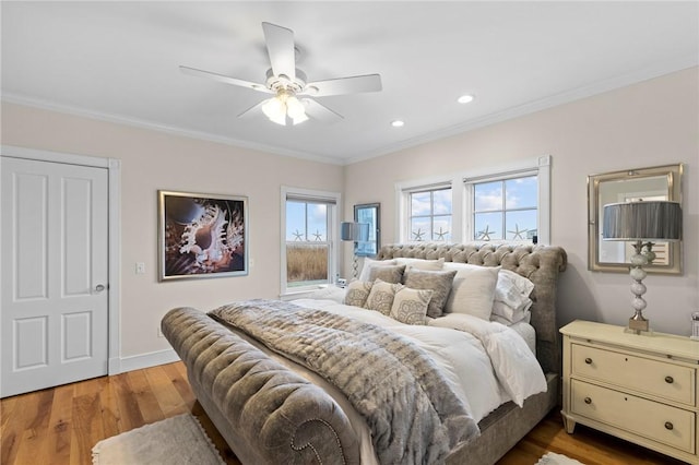 bedroom featuring hardwood / wood-style flooring, ceiling fan, and ornamental molding