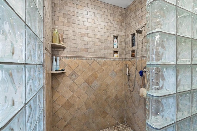 bathroom with a tile shower