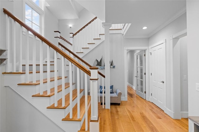 entrance foyer featuring light hardwood / wood-style flooring and ornamental molding