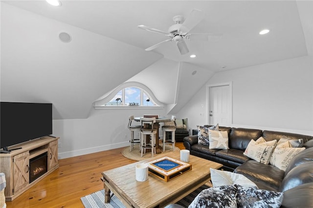 living room with vaulted ceiling, light hardwood / wood-style flooring, and ceiling fan