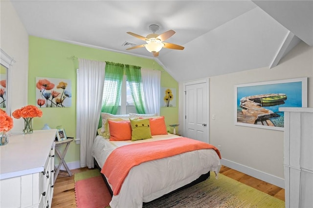 bedroom featuring ceiling fan, light wood-type flooring, and lofted ceiling