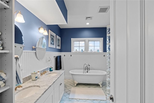 bathroom with a washtub and vanity