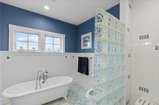 bathroom with separate shower and tub and tile patterned flooring