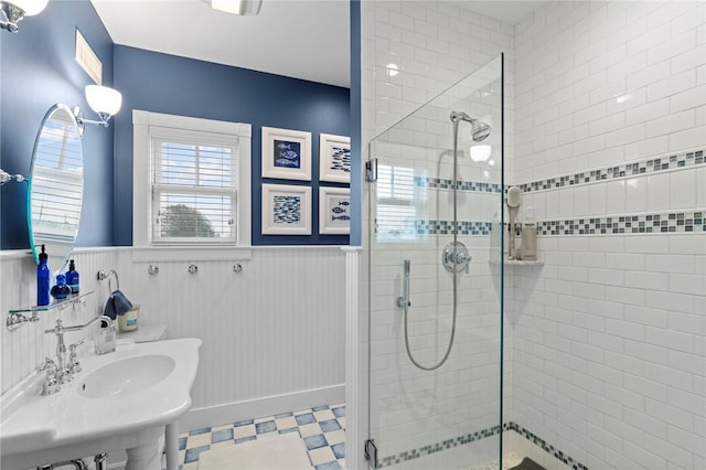 bathroom with sink and tiled shower