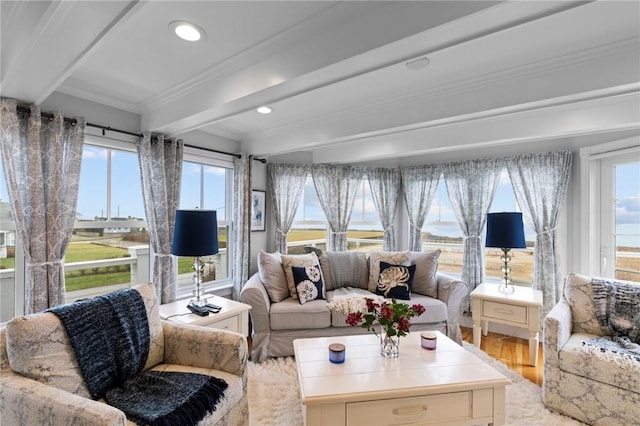 sunroom featuring beam ceiling and plenty of natural light